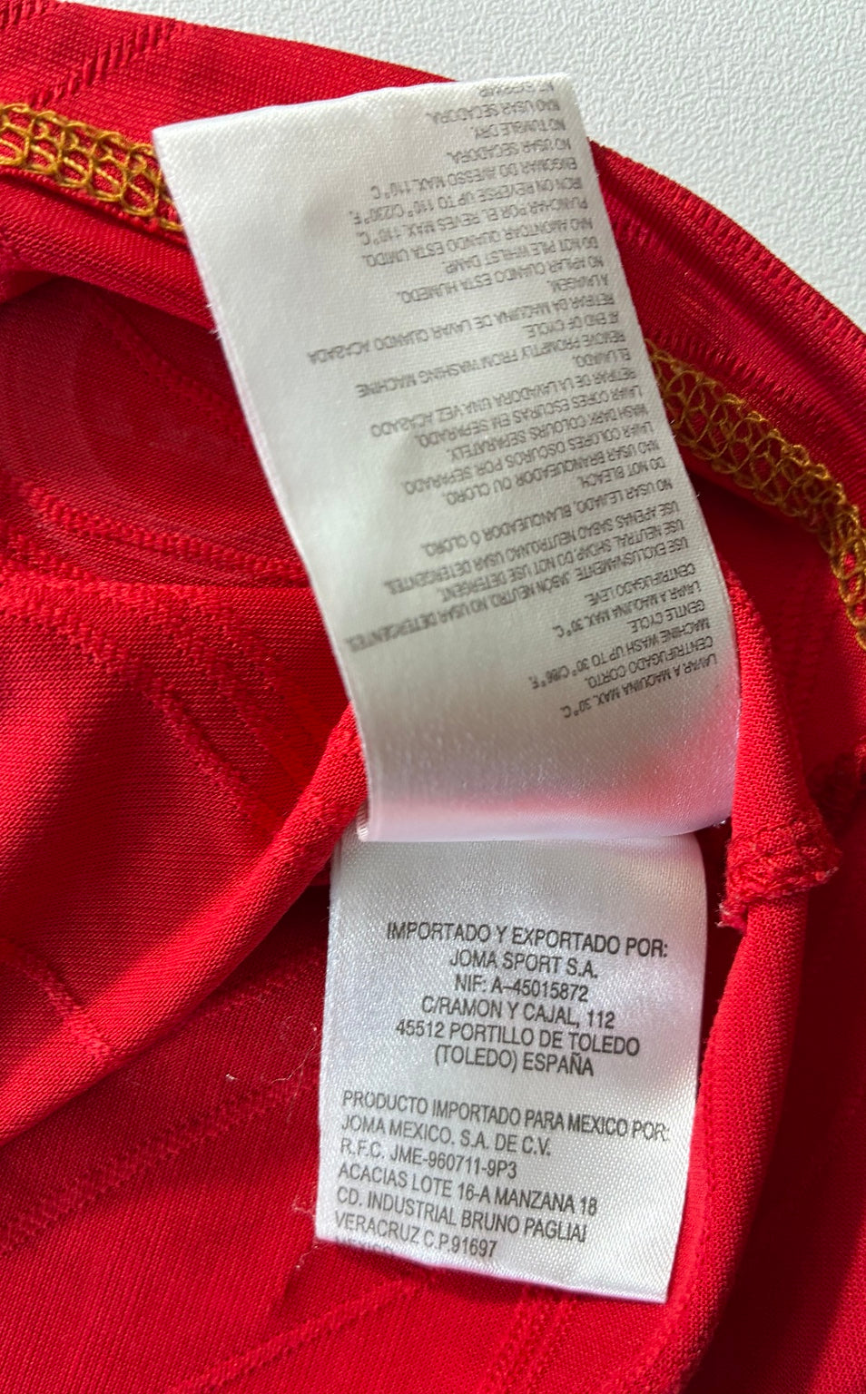 Sevilla red and gold Joma shirt — label detail