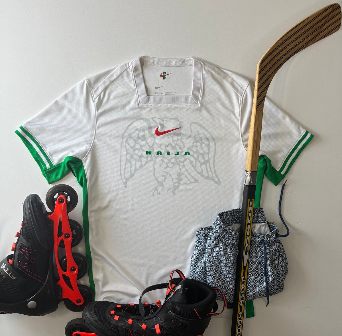 Nigeria 2024-25 Nike home shirt size Large styled flat lay with sports gear